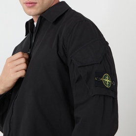 Model wearing Stone Island black cotton casual shirt, zip-up collar, signature compass badge on sleeve pocket