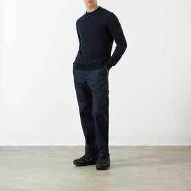Model wearing Stone Island blue wool crew neck jumper, styled with navy cargo trousers and black chunky trainers.