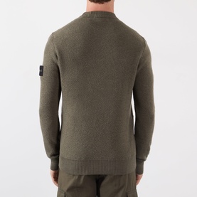 Model wearing Stone Island Verde Militare Melange wool crew neck jumper, rear view showing compass badge on left sleeve.