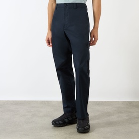 Model wearing Stone Island blue cotton chino trousers with a straight leg fit and belt loops, styled with dark chunky-soled shoes.