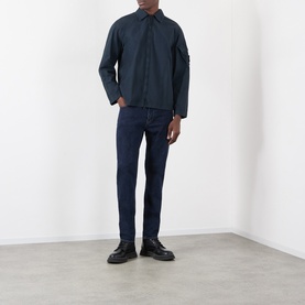 Model wearing Stone Island Blue Rinse jeans with a navy overshirt and black leather shoes.
