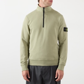Model wearing Stone Island Compass Logo Half-Zip Fleece Sweatshirt in laurel green, with funnel neck and sleeve badge detail.