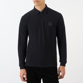 Model wearing Stone Island Compass Logo Long-Sleeved Polo Shirt in blue with logo patch, polo collar, and button fastenings