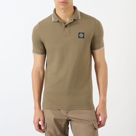 Model wearing Stone Island Compass Logo Tipped Polo Shirt in military green with white tipped collar and cuffs, patch badge logo.