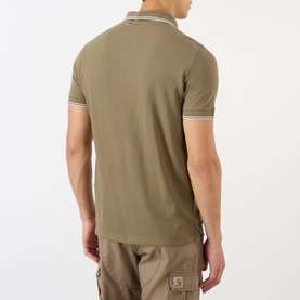 Model wearing Stone Island Compass Logo Tipped Polo Shirt in military green, back view, with tipped collar detail and khaki cargo trousers.