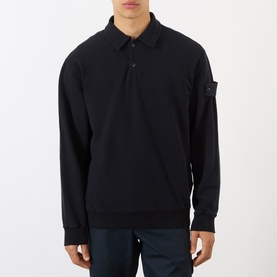 Model wearing black long-sleeve polo sweatshirt with button placket, spread collar, and C.P. Company arm lens badge
