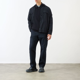 Model wearing navy zip-up overshirt jacket with chest pocket, styled with dark trousers and black chunky sole shoes