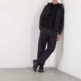 Model wearing Stone Island Compass Logo T-Shirt in black, styled with a dark zip-up hoodie, cargo trousers, and black chunky trainers.