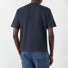 Model wearing Stone Island Navy Compass Patch Logo T-Shirt, back view, styled with blue trousers.