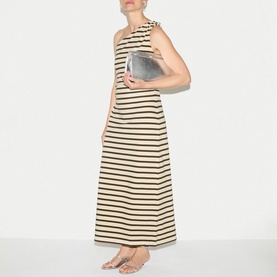 Model wearing Jigsaw khaki stripe maxi dress, styled with a silver metallic clutch bag