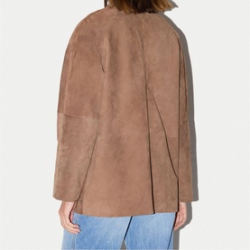 Model wearing Jigsaw light brown suede-effect collarless jacket, back view, styled with blue jeans.
