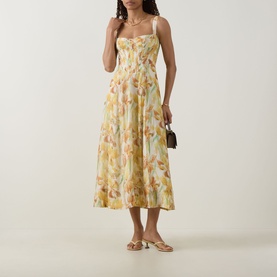 Model wearing Bardot Adaline Floral Print Dress in yellow floral, midi length with sweetheart neckline and flared skirt, styled with strappy heels