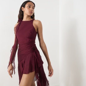 Model wearing Bardot Ivana Textured Mini Dress in deep plum with racer neckline, circle-cut ruffles, and high-low hem