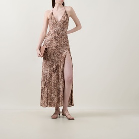Model wearing Bardot Lizbeth Leopard Slip Dress in leopard print, halter neckline, high side split maxi length, styled with heeled mules and clutch