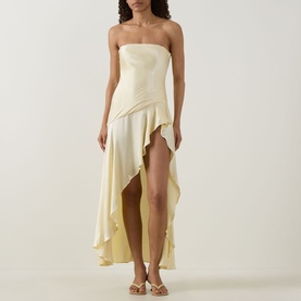 Model wearing Bardot Lorenzo Asymmetric Off-The-Shoulder Dress in yellow, satin finish, bandeau neckline, asymmetric hi-low ruffled skirt, styled