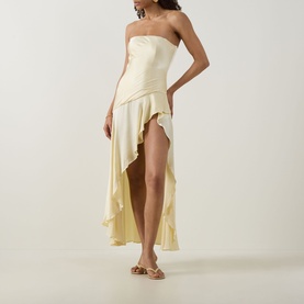 Model wearing Bardot Lorenzo Asymmetric Off-The-Shoulder Dress in yellow satin, gathered bandeau bodice, asymmetric flared skirt, styled with gold