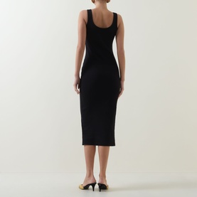 Model wearing Bardot Mason Ribbed Dress in black, ribbed midi length with scooped back neckline and wide tank straps, styled with black heels.