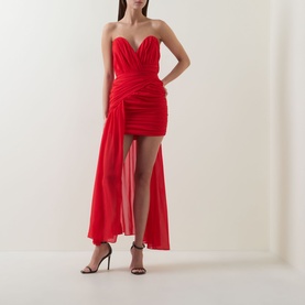 Model wearing Bardot Remalia Gathered Mini Dress in fire red, strapless sweetheart neckline, draped panel, styled with black strappy heels