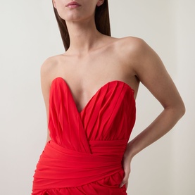 Model wearing Bardot Remalia Gathered Mini Dress in Fire Red, strapless sweetheart neckline with structured boned bodice and gathered panel detail.
