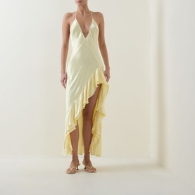 Model wearing Bardot canary yellow halterneck wrap dress with ruffle hem, styled with gold flat sandals