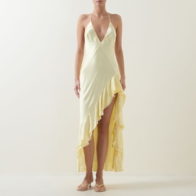 Model wearing Bardot canary yellow halterneck maxi dress with V-neckline, ruffle hi-low hem, and strappy sandals