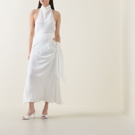 Model wearing Bardot Solene Cut-Out Skirt in Orchid White with gathered detailing and side tie, styled with a white halterneck top and heeled mules.