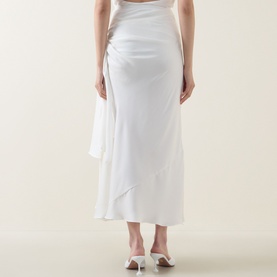 Model wearing Bardot Solene Cut-Out Skirt in Orchid White, showing rear view with gathered detailing, side tie and flared hem, styled with white