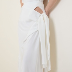 Model wearing Bardot Solene Cut-Out Skirt in Orchid White, showing side cut-out detail with gathered fabric and adjustable tie fastening.