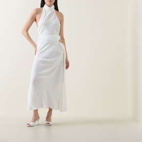 Model wearing Bardot Solene Cut-Out Skirt in Orchid White with flared hem and side cut-out, styled with a white halterneck top and heeled mules.