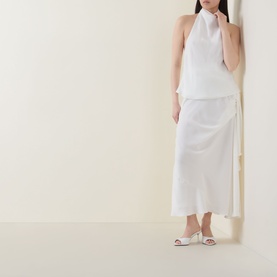 Model wearing Bardot Solene Draped Blouse in white with high cowl neckline, styled with matching white midi skirt and white heeled mules.