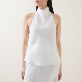 Model wearing Bardot Solene Draped Blouse in Orchid White, styled with a white skirt. Sleeveless halter silhouette with high cowl neckline.