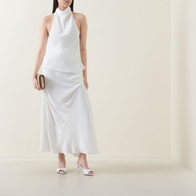 Model wearing Bardot Solene Draped Blouse in white with high cowl neck, styled with a white midi skirt, gold clutch and white heeled mules.