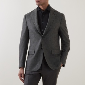 Model wearing Corneliani grey green virgin wool tailored jacket with notch lapels and two-button front, styled with dark trousers
