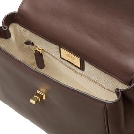 Lauren chestnut brown leather crossbody bag, open interior view showing cream lining, zip pocket, and gold-tone hardware details.
