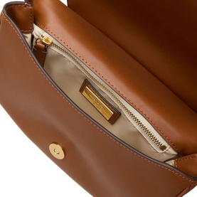Lauren tan leather crossbody bag, open top view showing cream fabric lining, gold zip and branded gold interior plaque
