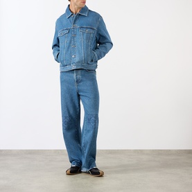 Model wearing Loewe Anagram Logo Denim Jacket in jeans blue with matching denim jeans and dark loafers.