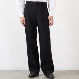 Model wearing Loewe black wide-leg wool casual trousers, styled with a white shirt and black leather shoes.