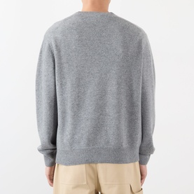 Model wearing Loewe Anagram Logo Sweater in grey melange wool, crew neck with ribbed trims, back view, styled with beige trousers