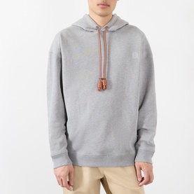 Model wearing Loewe grey melange cotton hoodie with tan drawstring tassel detail and subtle chest logo patch