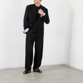 Model wearing Loewe black cotton T-shirt, styled with black blazer, wide-leg trousers, and dark leather shoes.