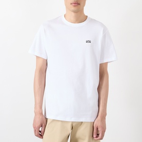 Model wearing Loewe white cotton T-shirt with small chest logo print, styled with beige trousers