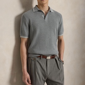 Model wearing RLX Golf knit polo in Spring Heather, tipped collar detail, styled with taupe trousers and brown belt