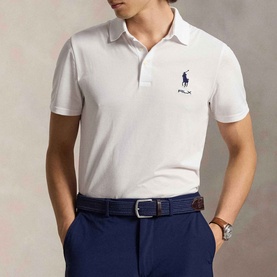 Model wearing RLX Golf polo in light green with navy Big Pony logo, styled with navy trousers and brown belt.
