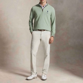 Model wearing RLX Golf Pony Logo Mesh Quarter-Zip Sweatshirt in light green, styled with white chinos and white trainers.