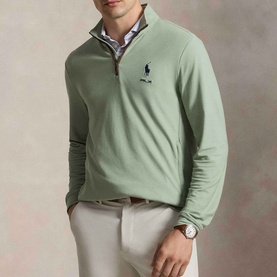 Model wearing RLX Golf Pony Logo Mesh Quarter-Zip Sweatshirt in light green with mock neck, styled with white trousers and a watch.