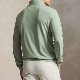 Model wearing RLX Golf Pony Logo Mesh Quarter-Zip Sweatshirt in light green, rear view, styled with white trousers