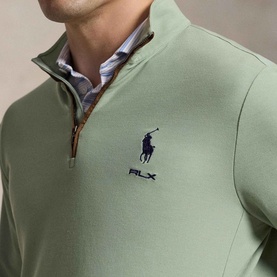 Model wearing RLX Golf Pony Logo Mesh Quarter-Zip Sweatshirt in light green with navy embroidered pony logo, styled with striped shirt underneath.