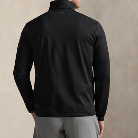 Model wearing RLX Golf black zip-neck sweatshirt, rear view, styled with grey trousers