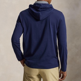 Model wearing RLX Golf Refined Navy hooded long-sleeve T-shirt, rear view, styled with beige chinos.