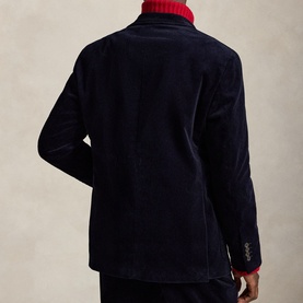 Model wearing navy corduroy blazer, back view, styled with red ribbed turtleneck